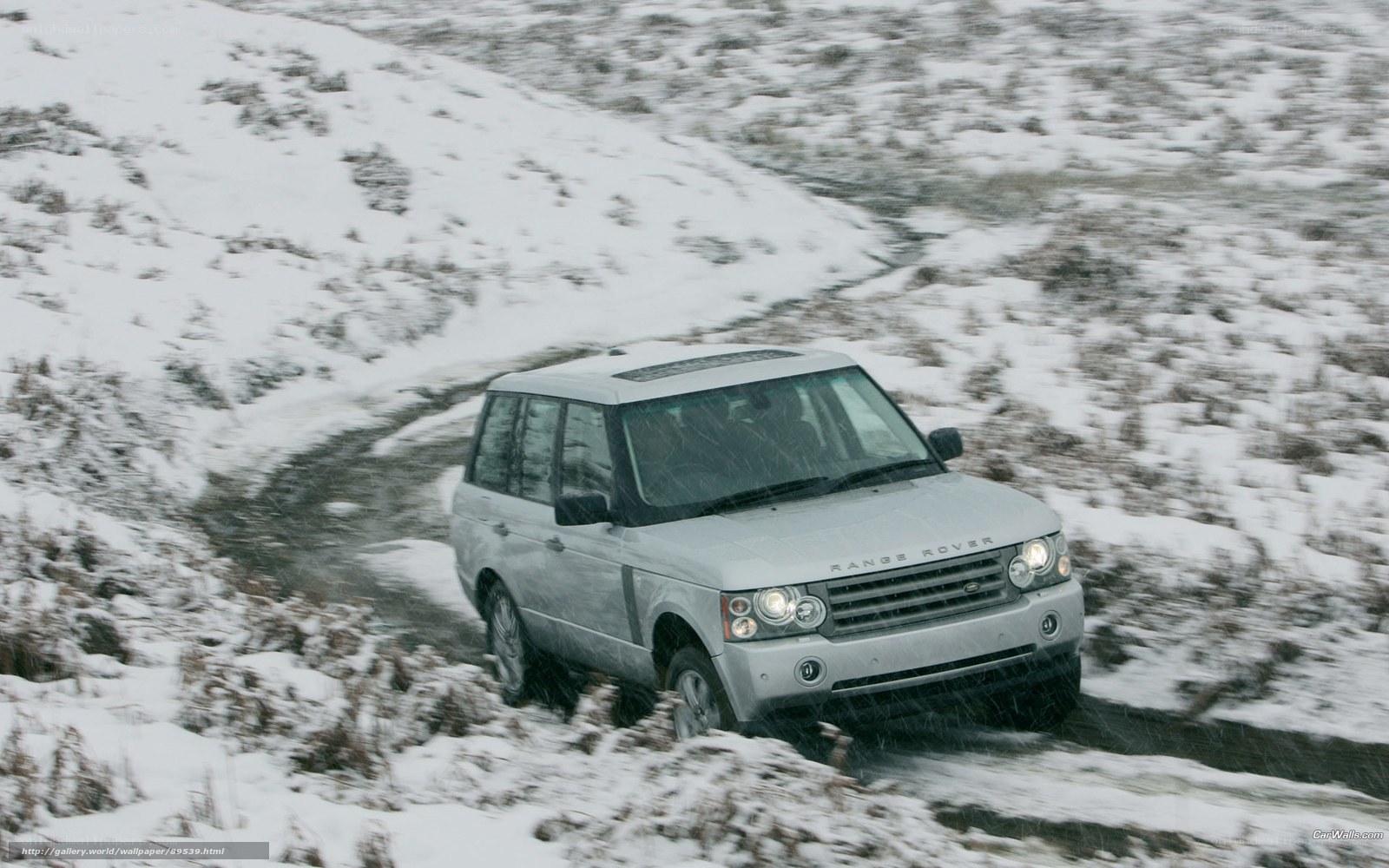 Silver Range Rover on snowy path