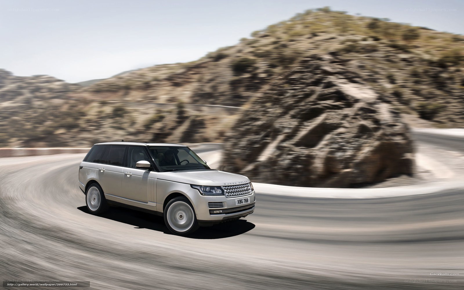 silver range rover on winding road