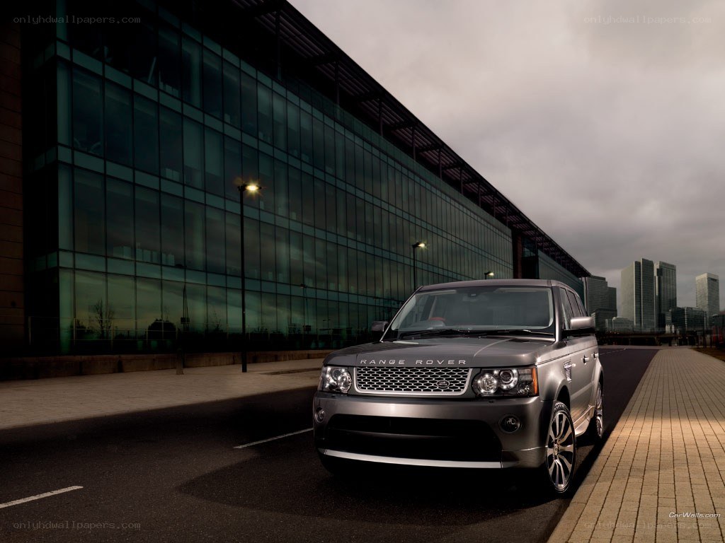Silver Range Rover parked outside modern building
