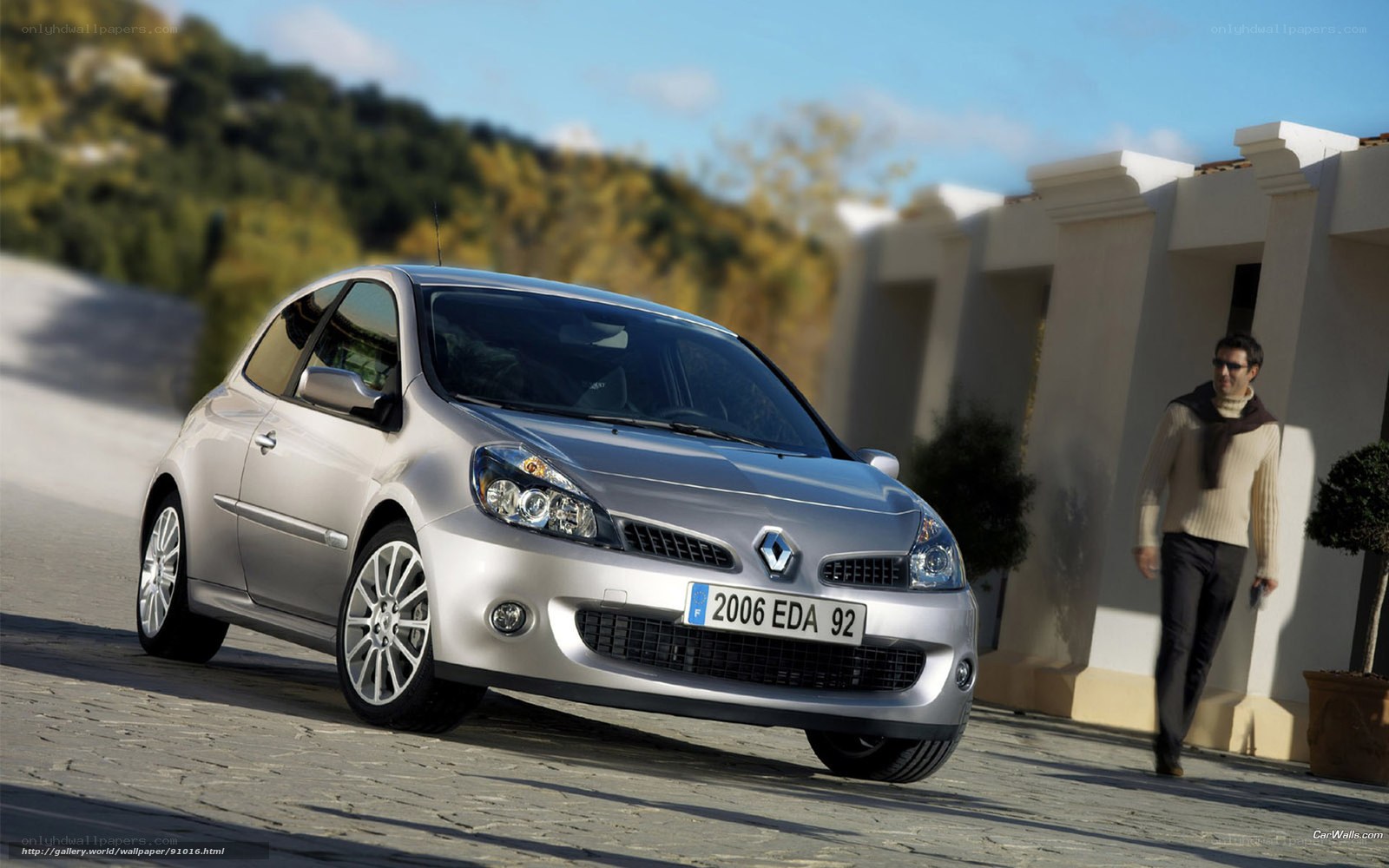 Silver Renault Clio on a cobblestone street