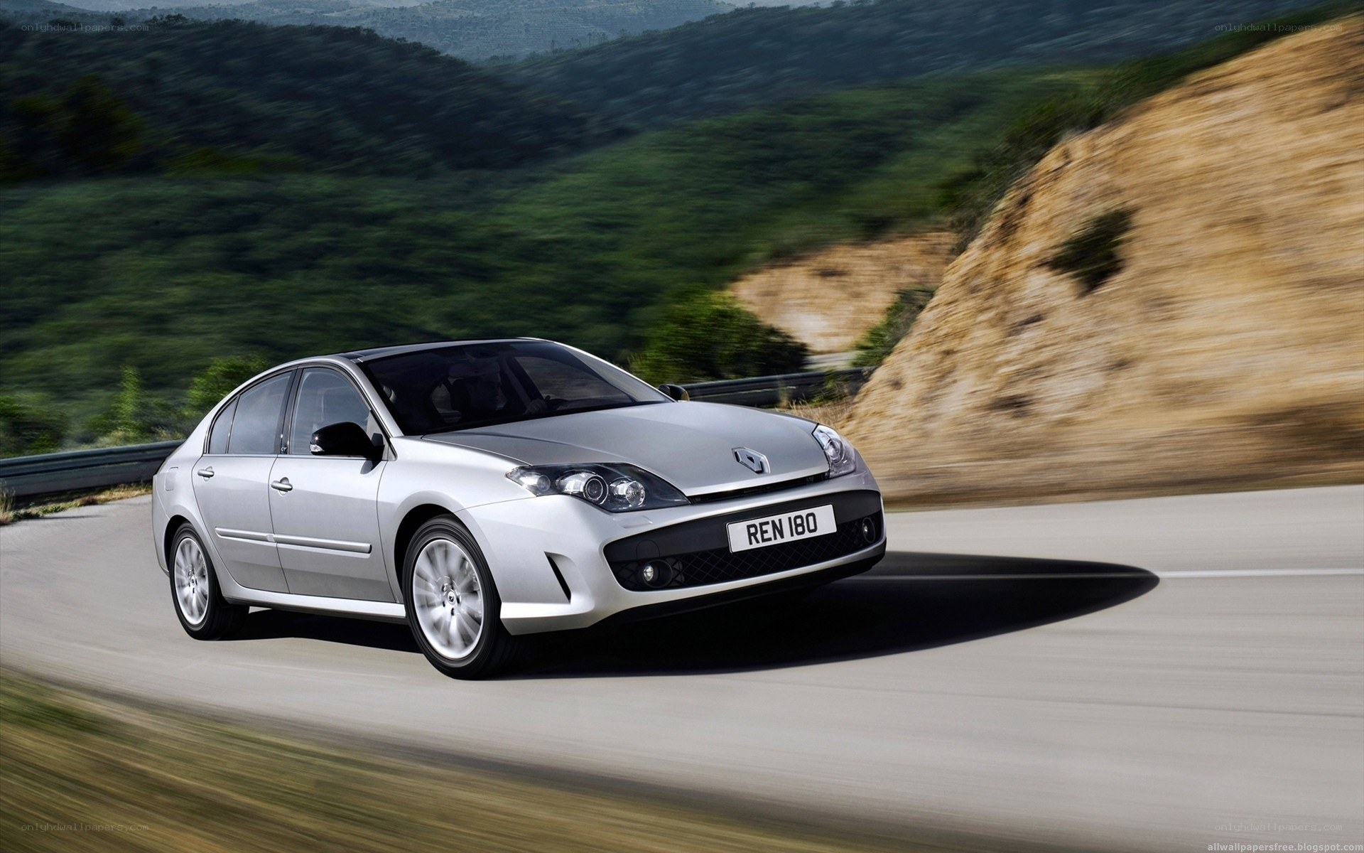 silver renault on winding road