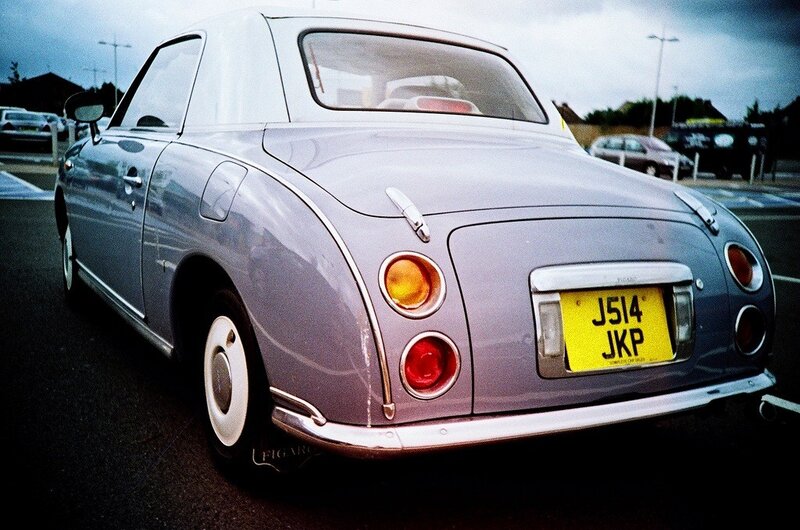 silver retro car in parking lot