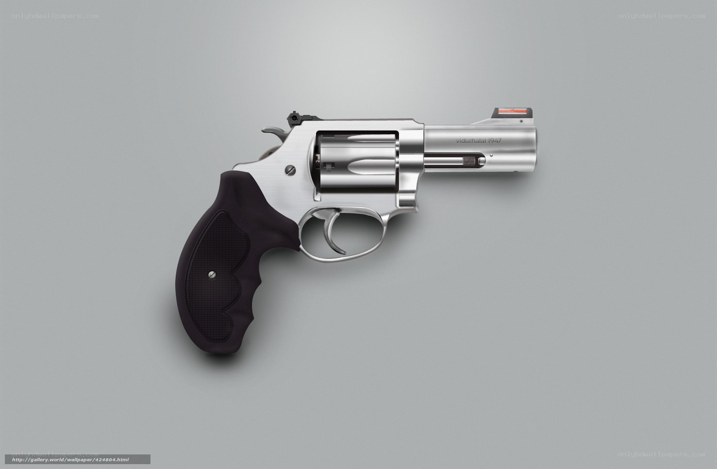 silver revolver on gray background