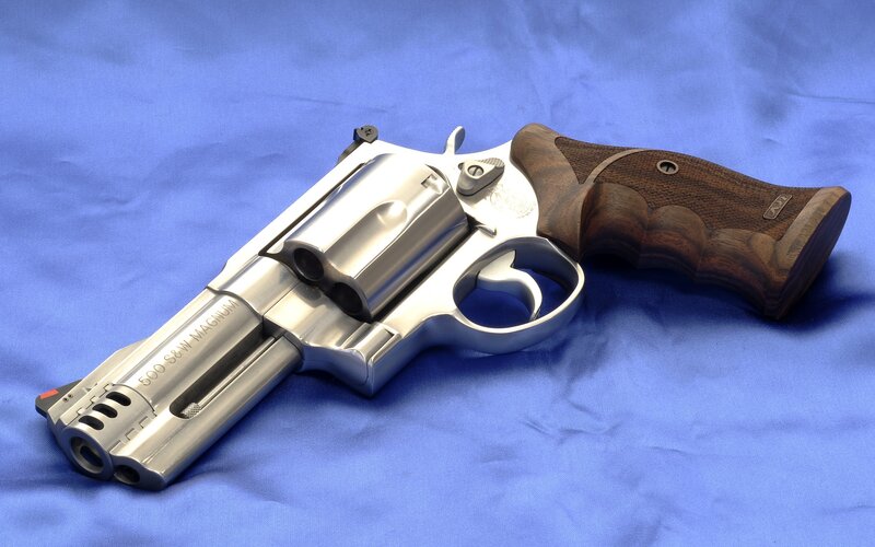 silver revolver with wooden grip
