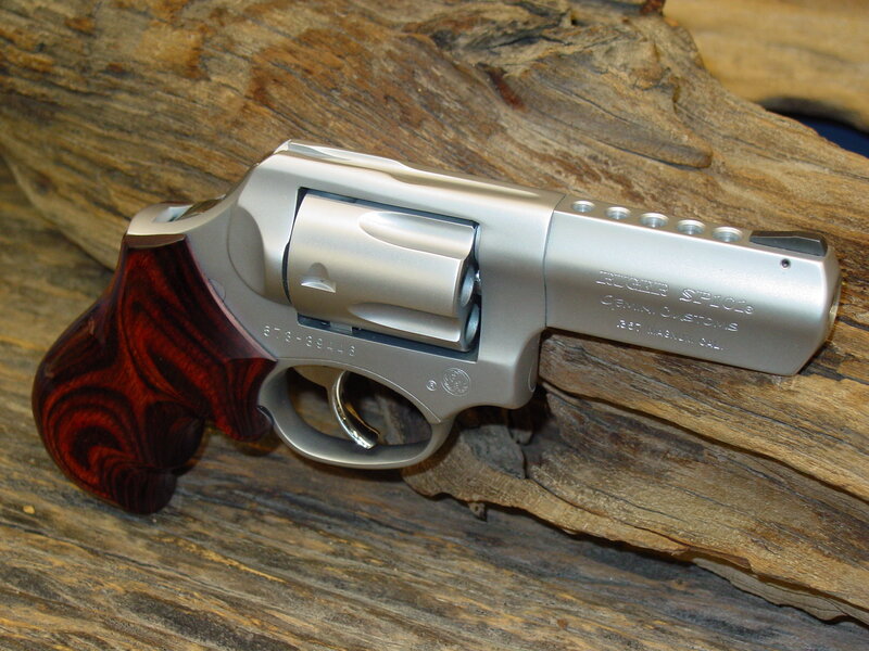 silver revolver with wooden grip