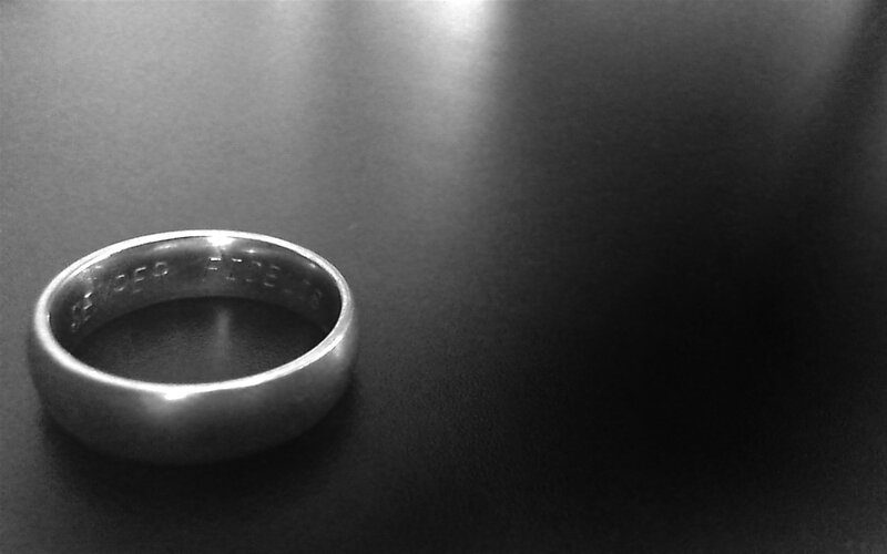 silver ring on dark surface
