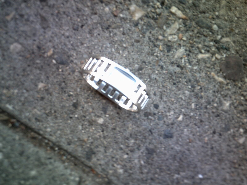 silver ring on pavement