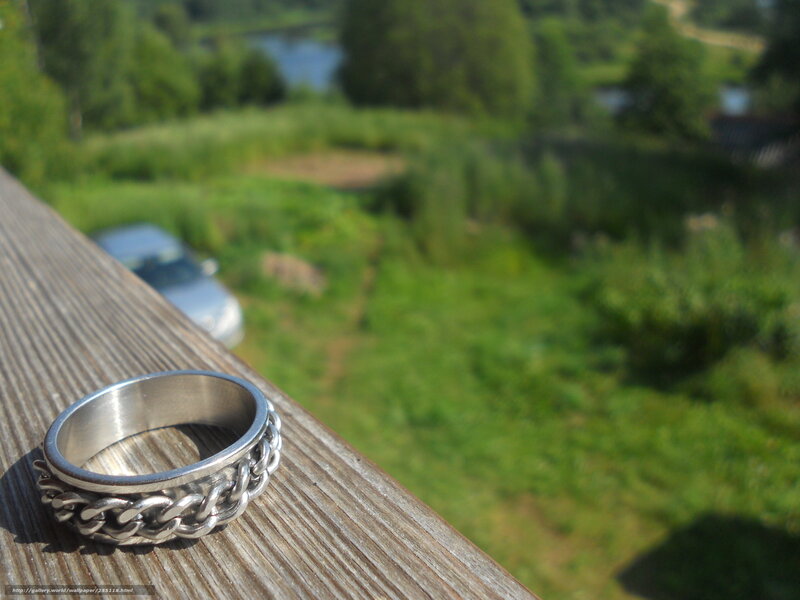 silver ring on wooden railing