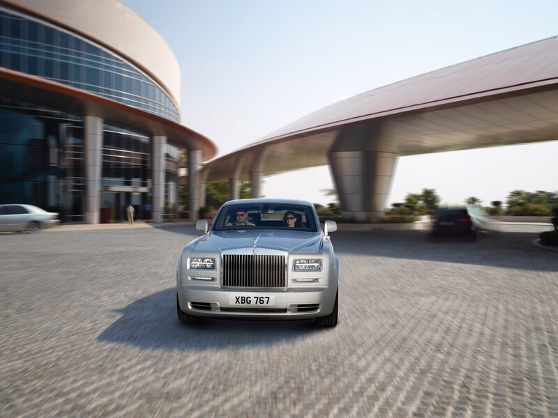 Silver Rolls-Royce at modern building
