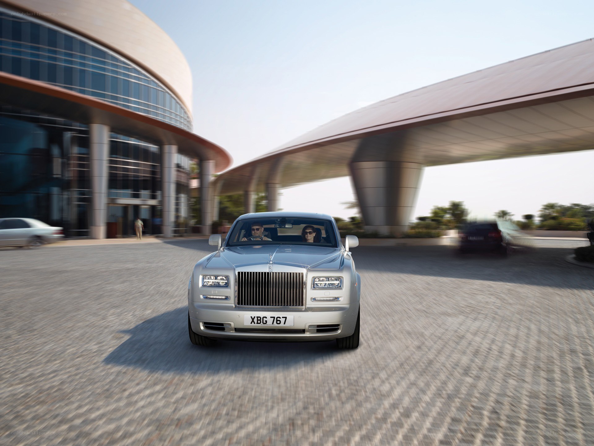 Silver Rolls-Royce at modern building