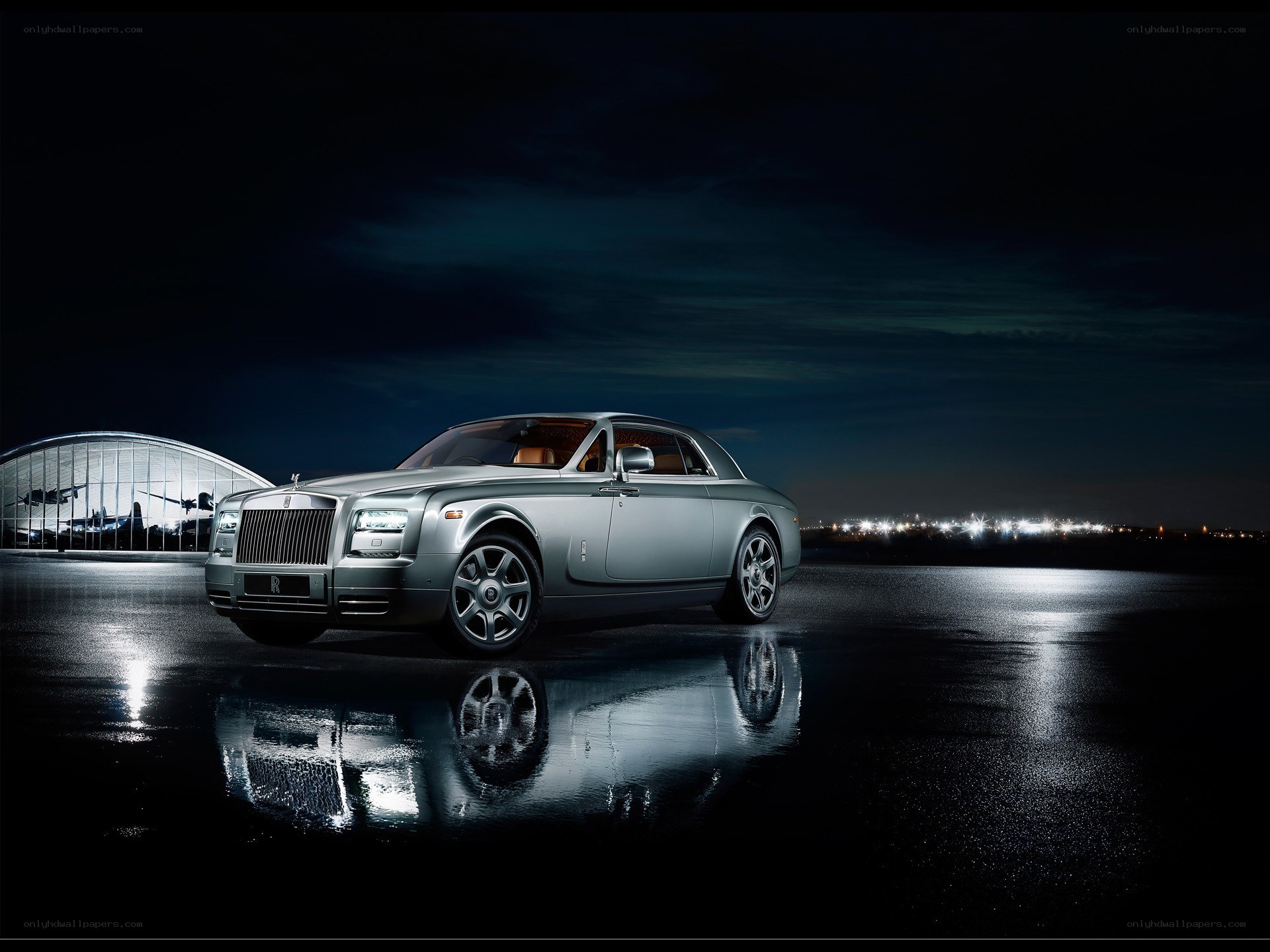 Silver Rolls-Royce at night