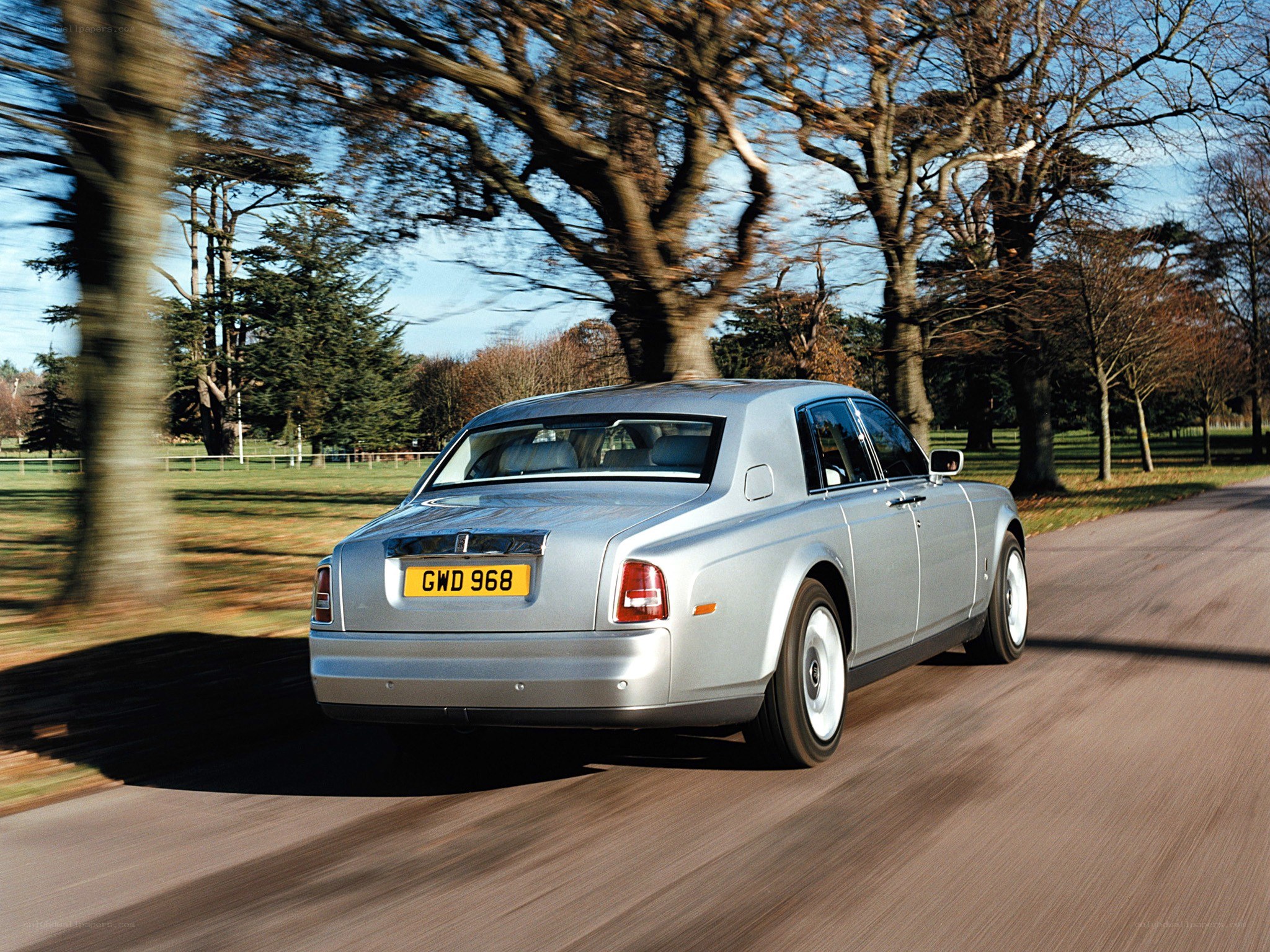 silver rolls-royce driving on road