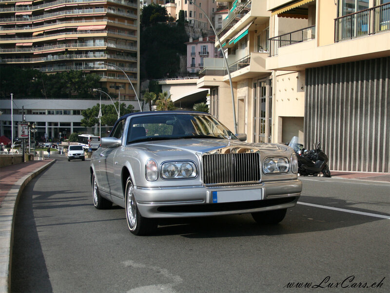 silver rolls-royce on a city street