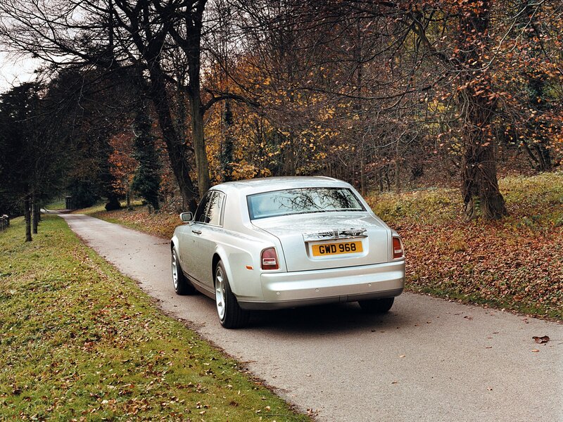 Silver Rolls-Royce on a forest road