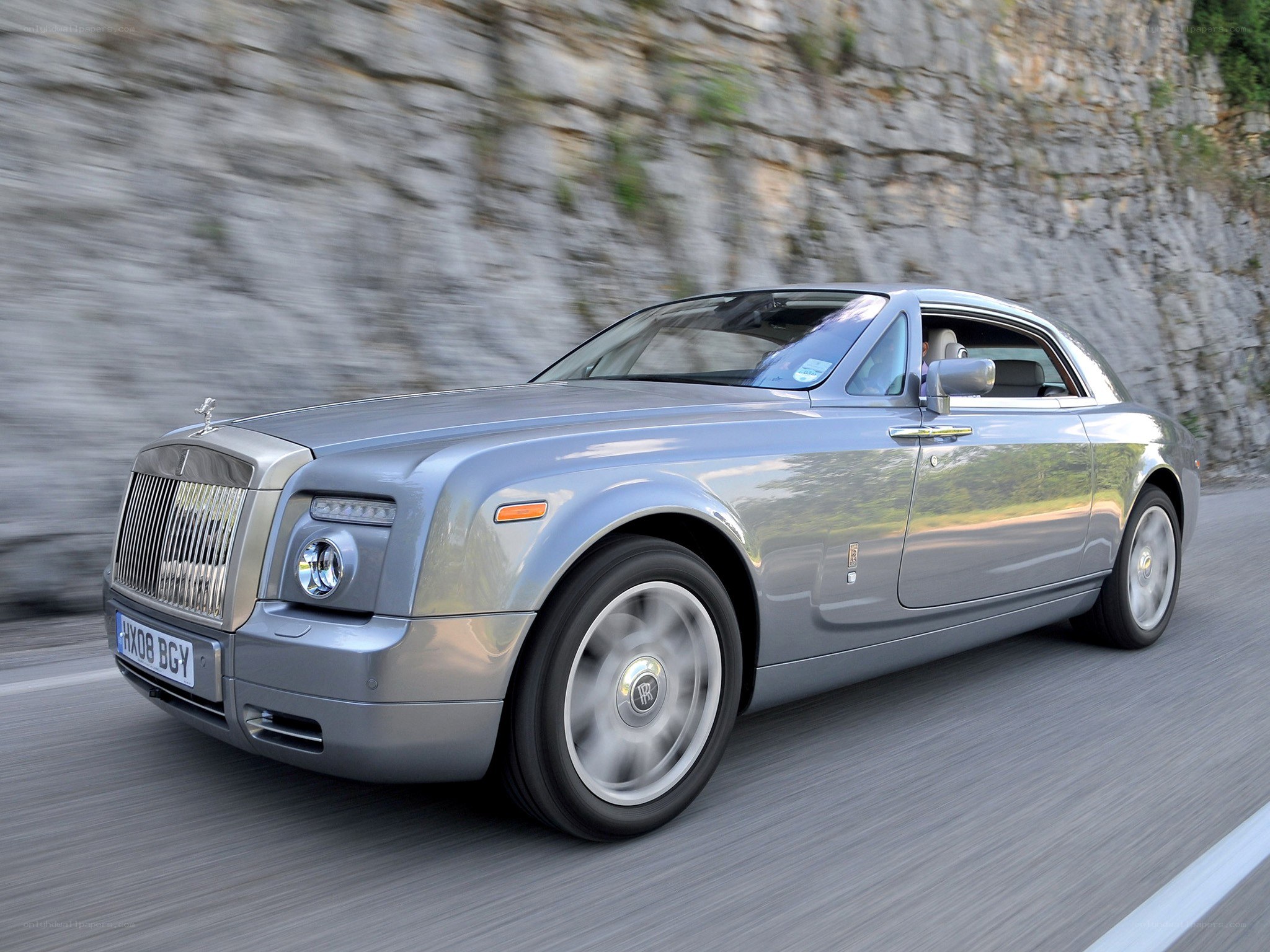 Silver Rolls-Royce on a mountain road