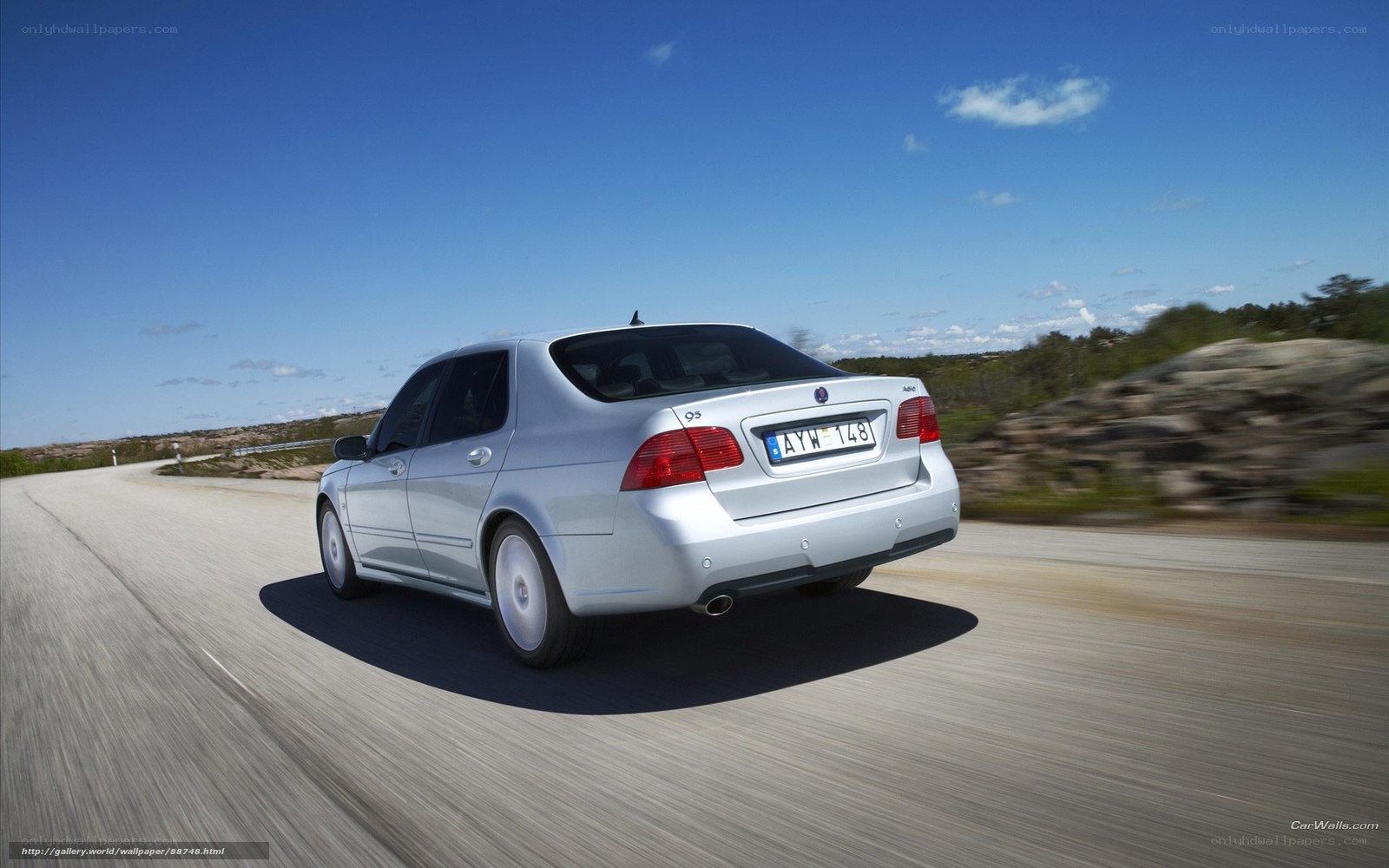 silver saab 9-5 driving on road