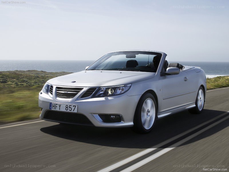 silver saab convertible on coastal road