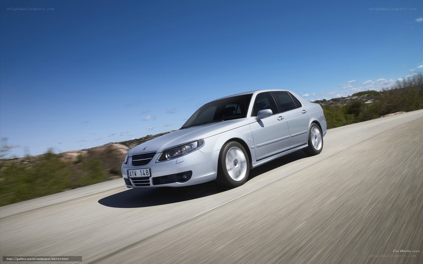 silver saab driving on road