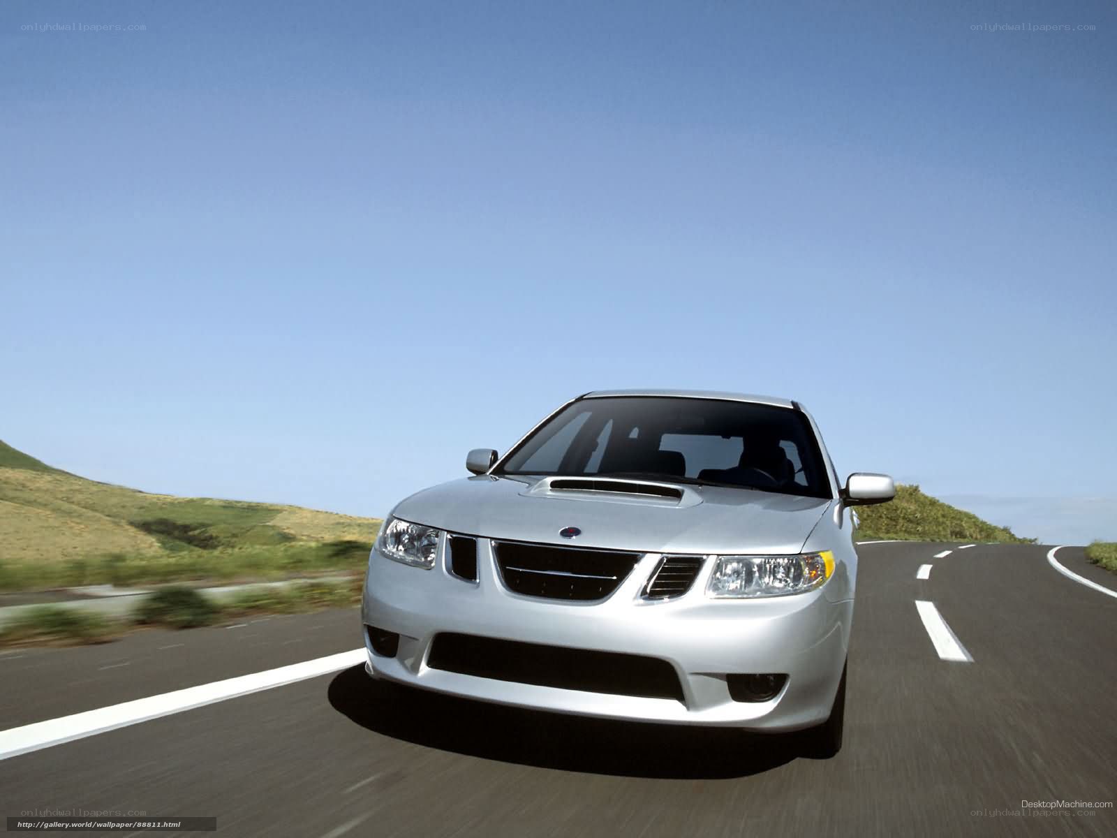 silver saab on a winding road