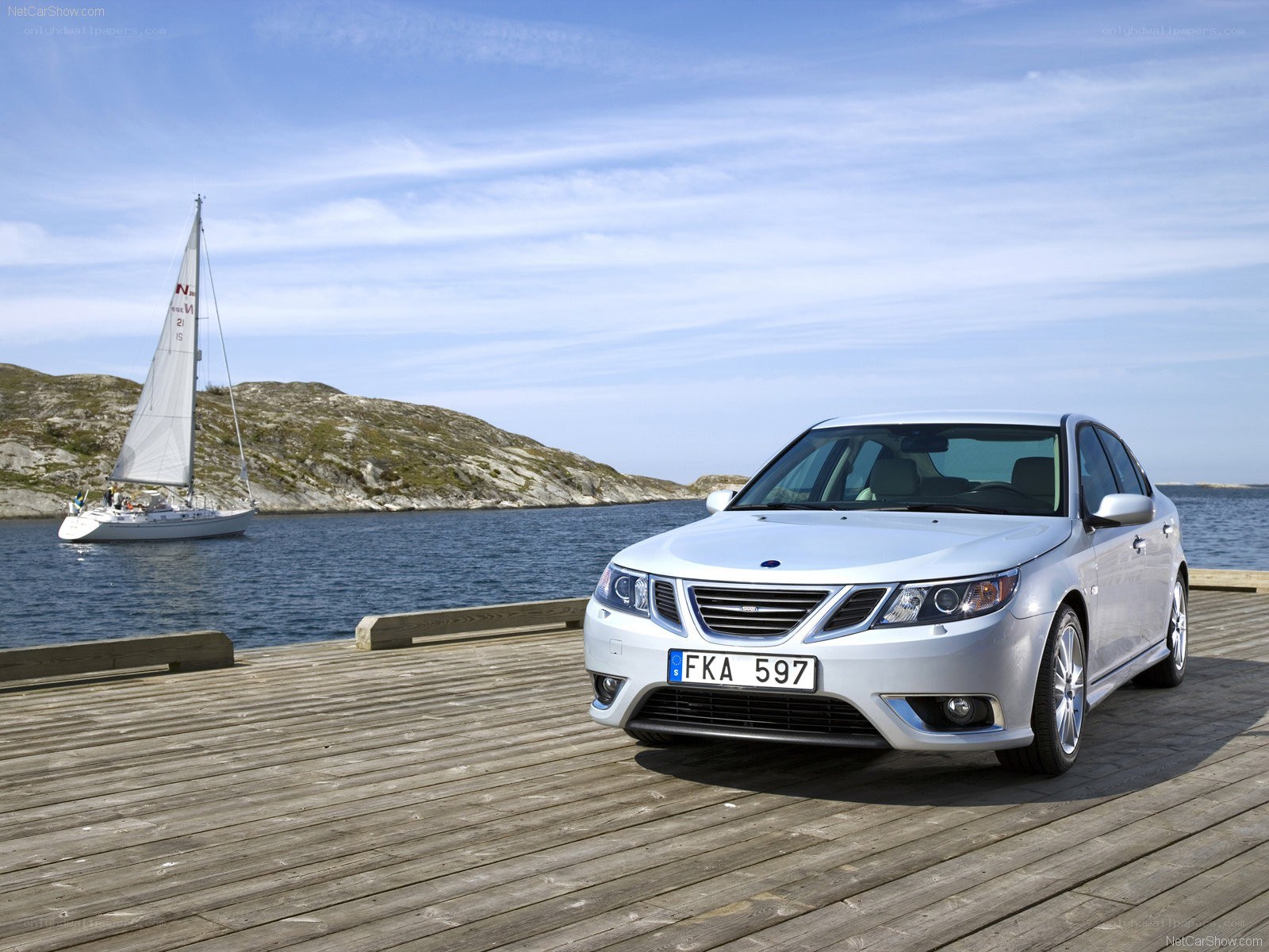 Silver Saab on a wooden dock