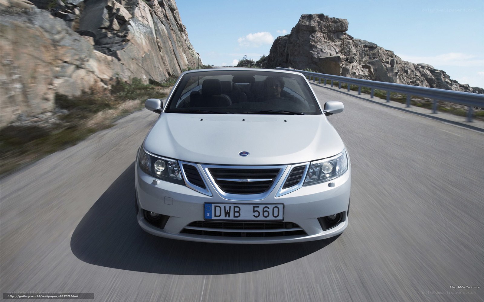 silver saab on coastal road