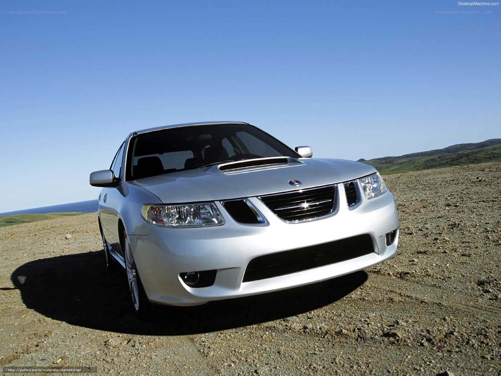 silver saab on gravel road