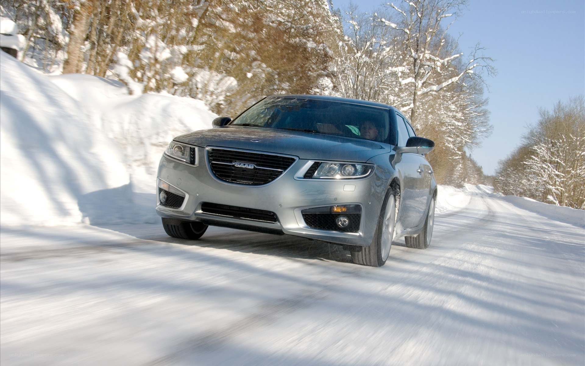 Silver Saab on snowy road