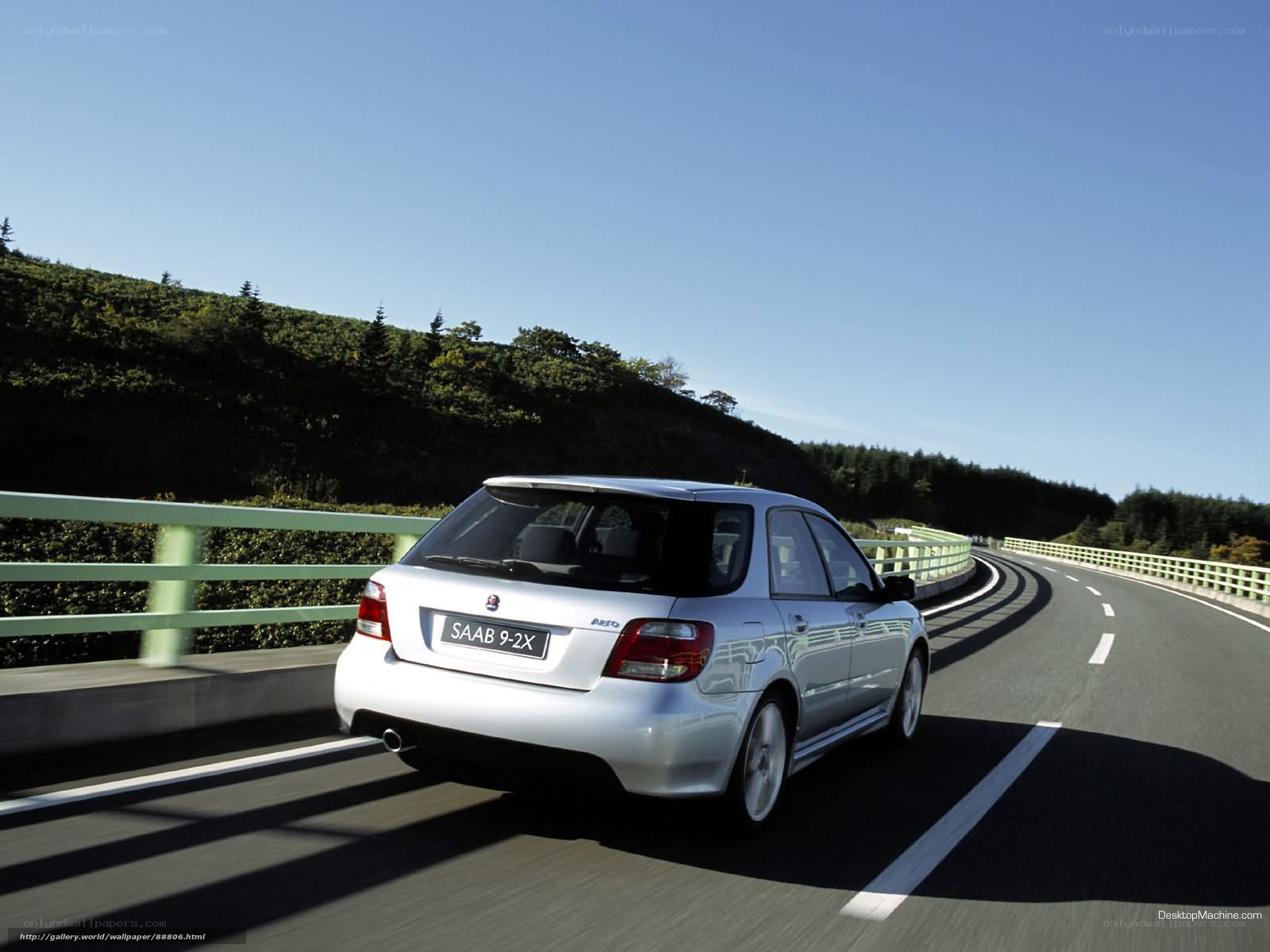 silver saab on winding road