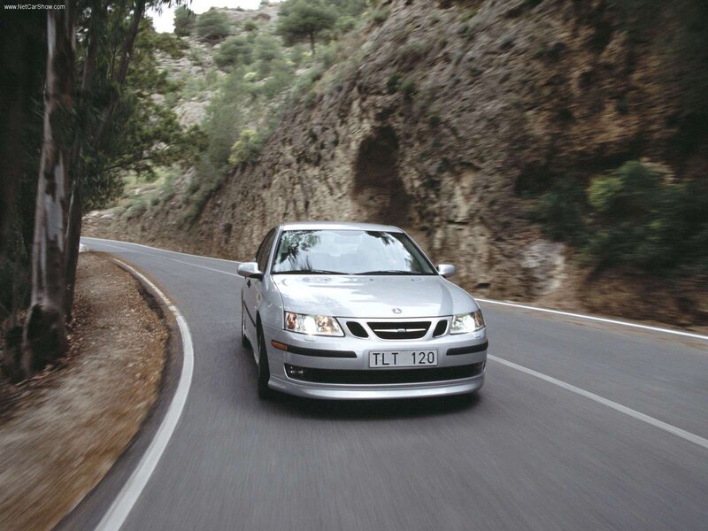 silver saab on winding road