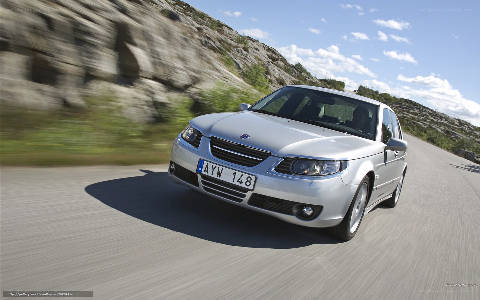 silver saab on winding road