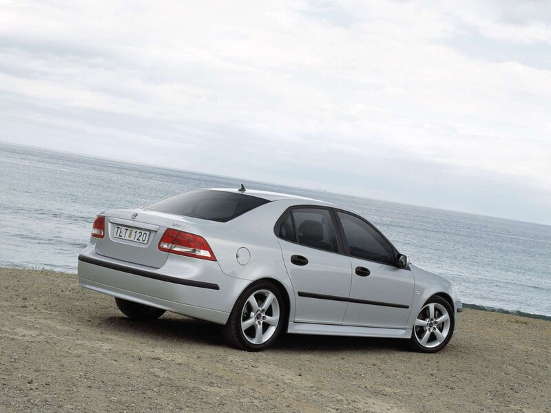 Silver Saab sedan by the sea