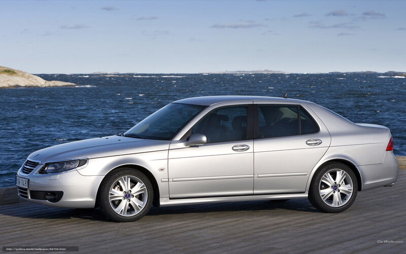 silver saab sedan by the sea