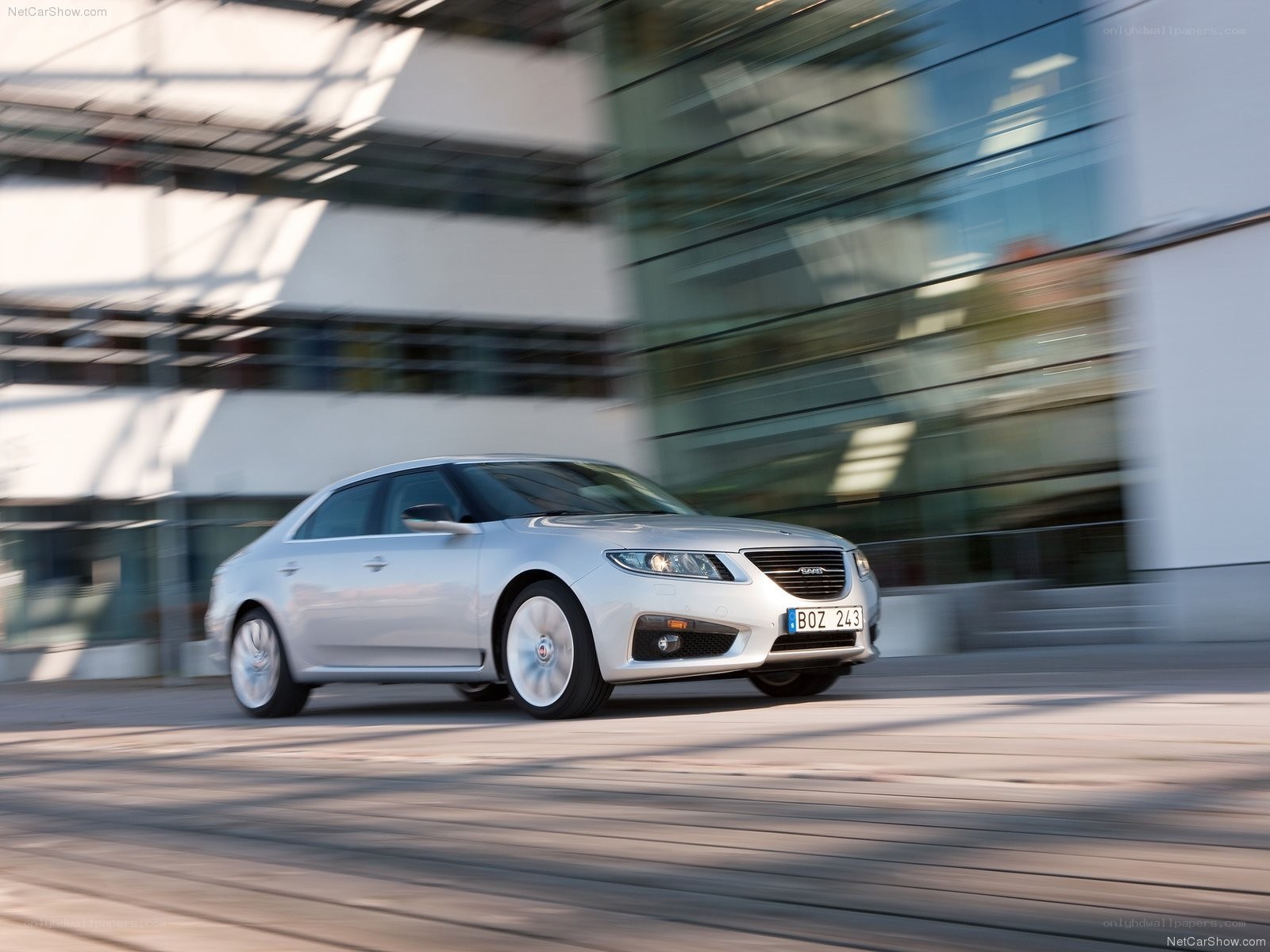 silver saab sedan in motion