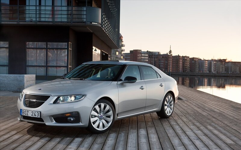 Silver Saab sedan on a dock