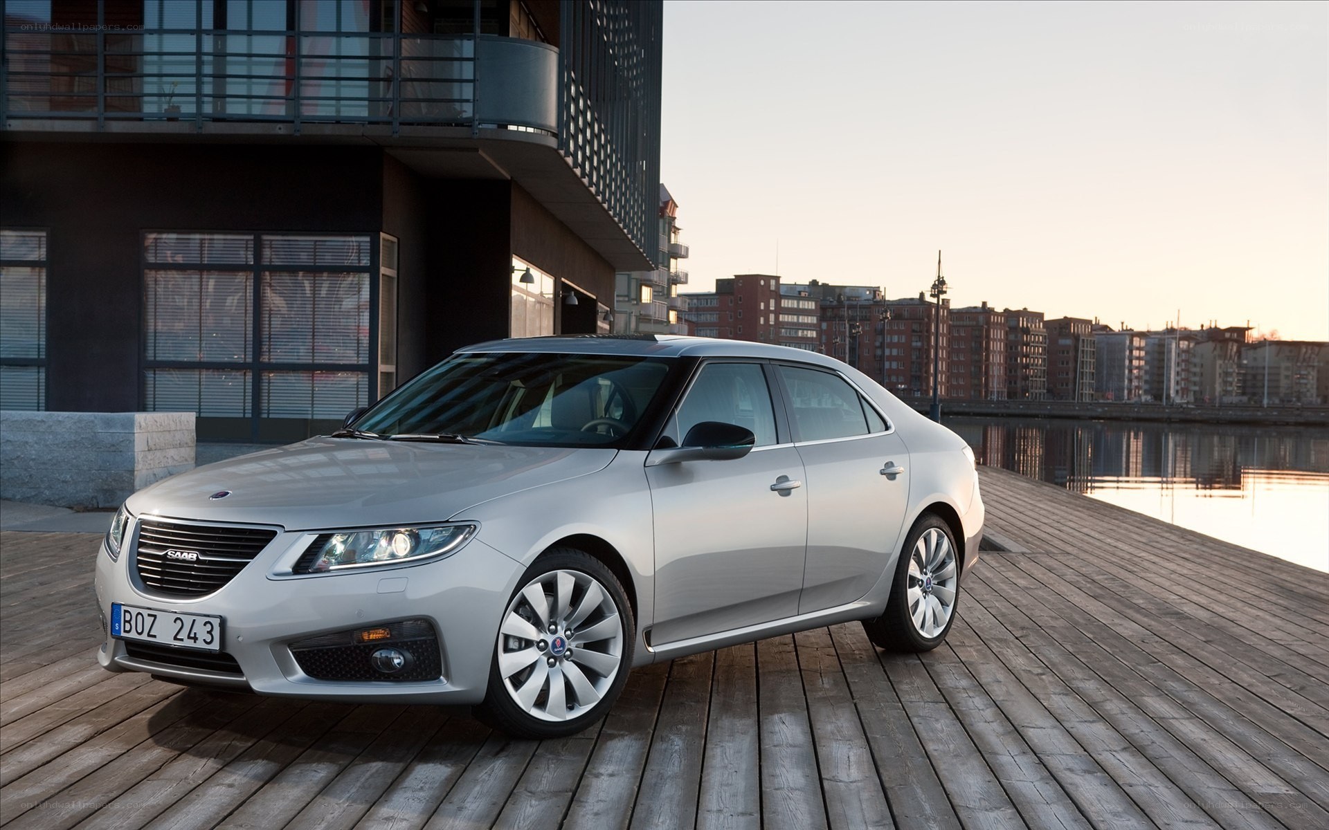Silver Saab sedan on a dock