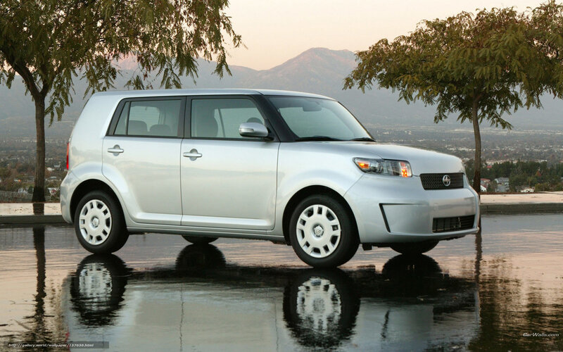 silver scion xB on wet pavement