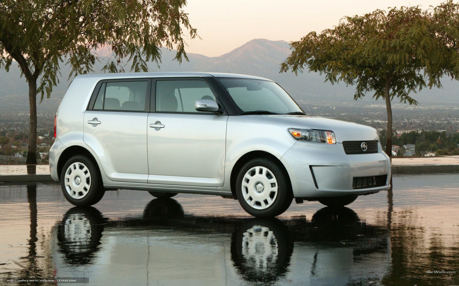 silver scion xB on wet pavement