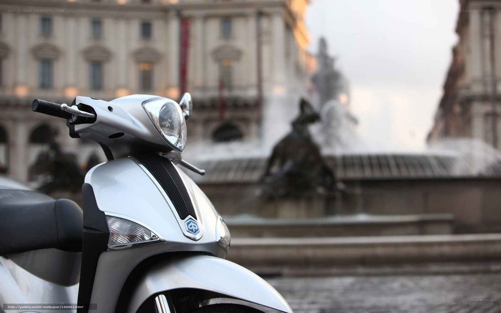 Silver scooter in city square