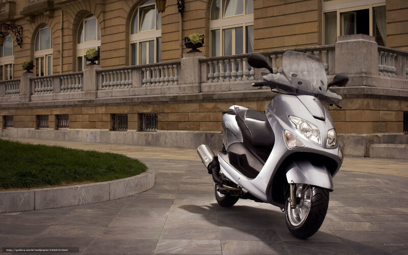 Silver scooter in front of building