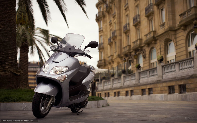 Silver scooter on city street