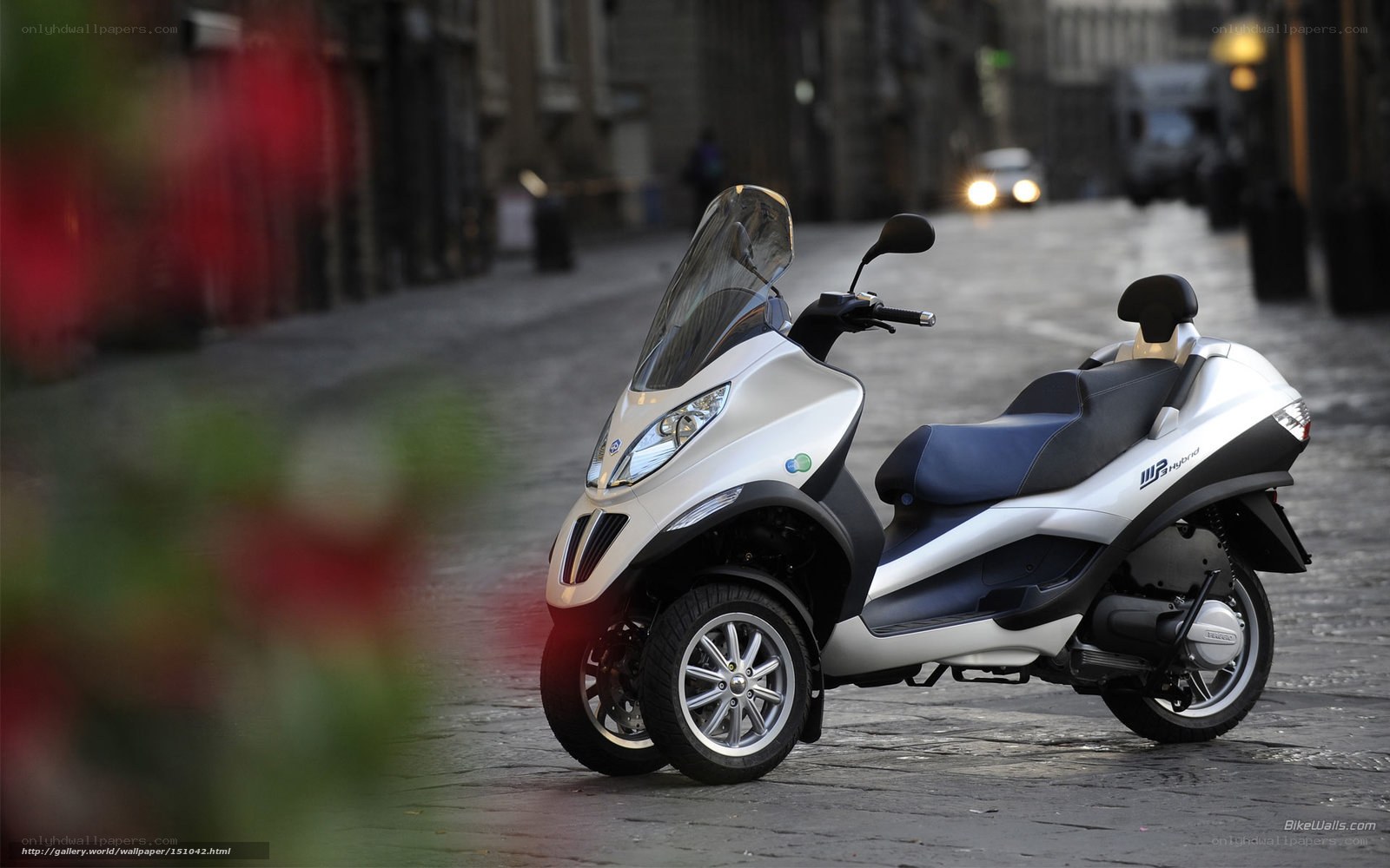 Silver scooter on cobblestone street