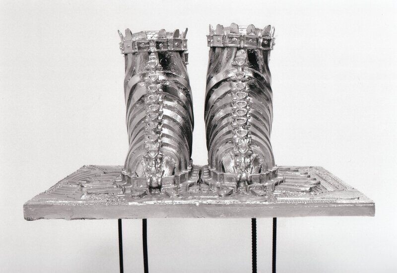 silver sculpture of boots