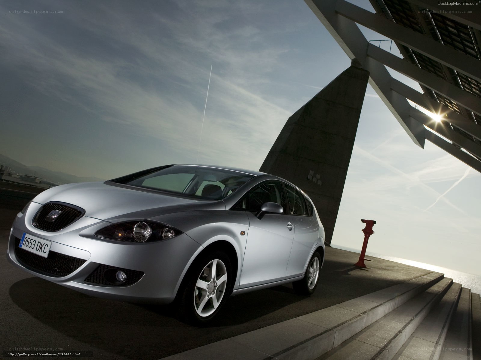 Silver SEAT Leon parked near modern structure