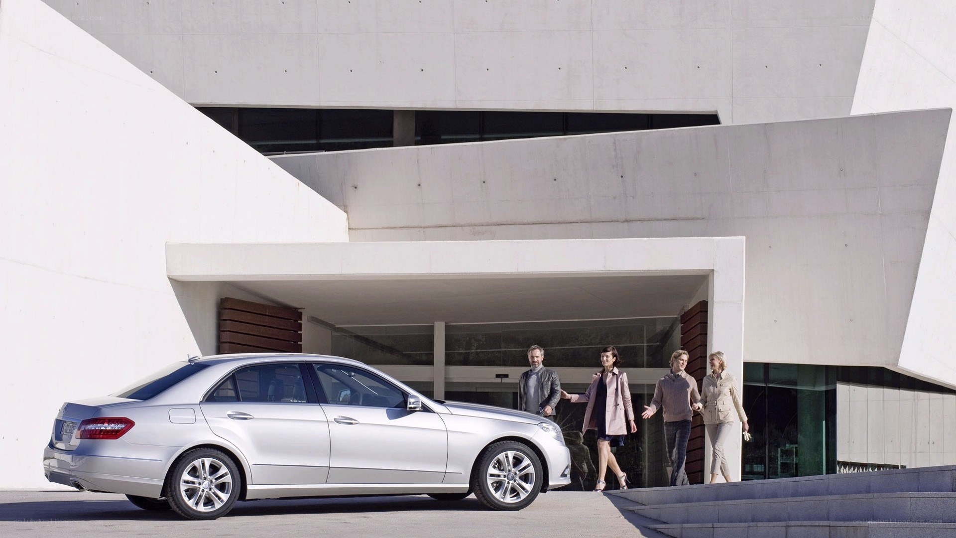 Silver sedan at modern building