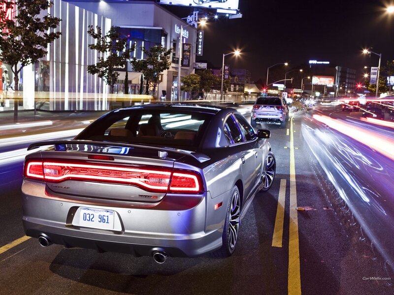 Silver sedan at night in city
