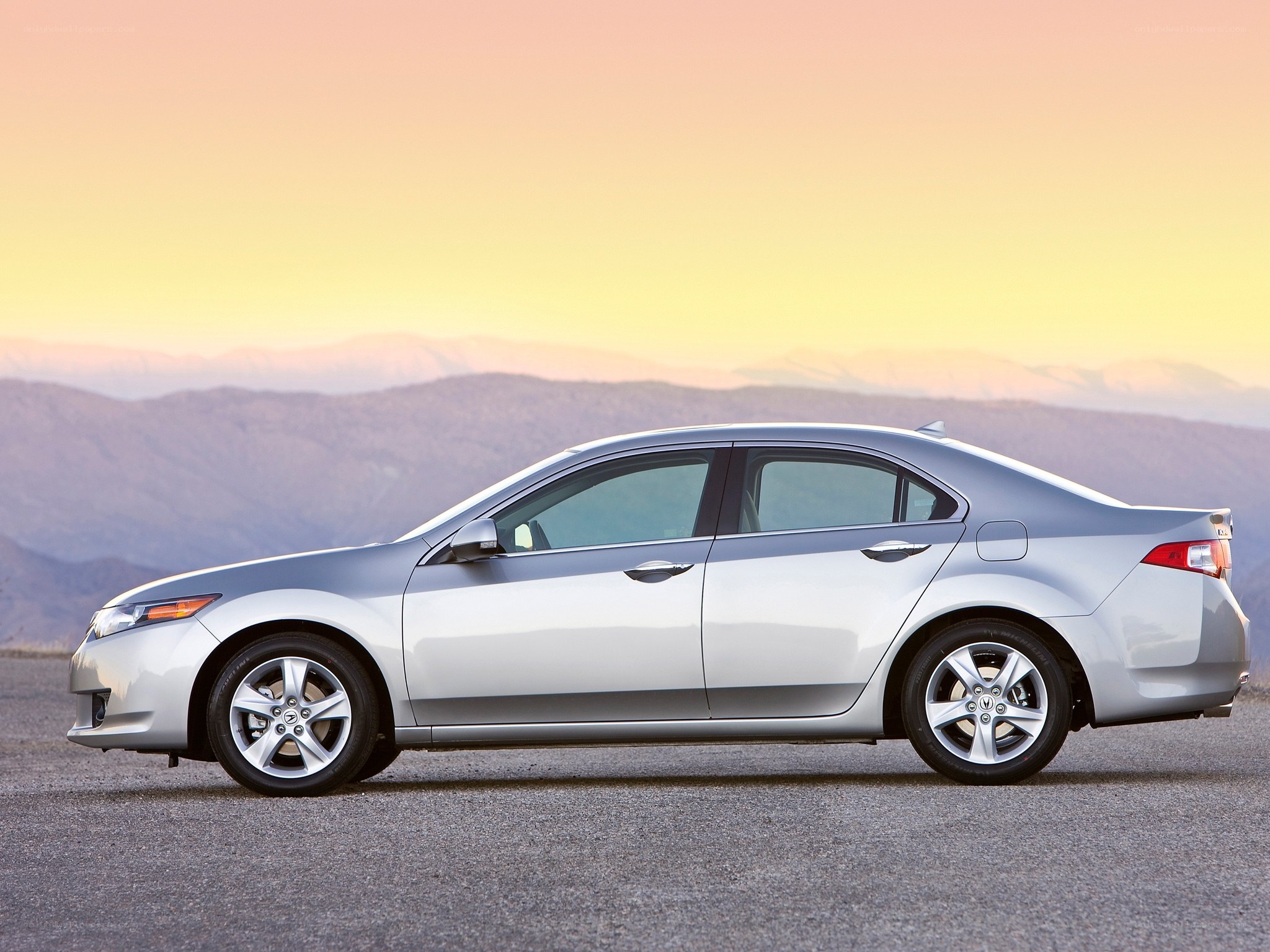 silver sedan at sunset