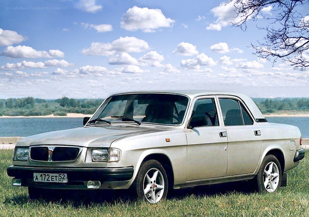 Silver sedan by a lake
