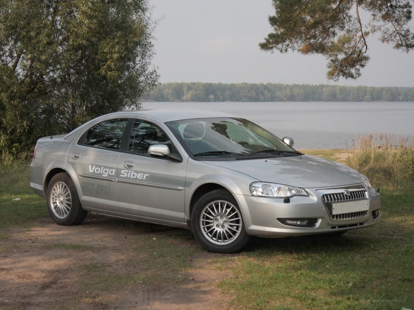 Silver sedan by a lake