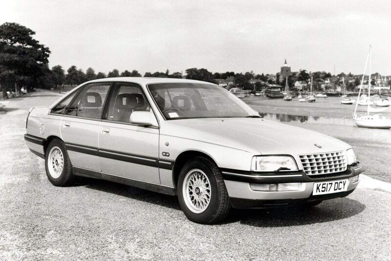 silver sedan by the harbor