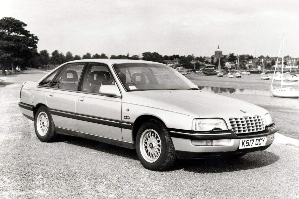 silver sedan by the harbor